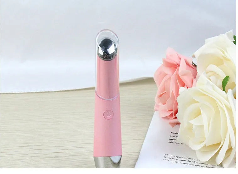 Mini electric eye massager pen in pink and white with vibration and heat for dark circles removal