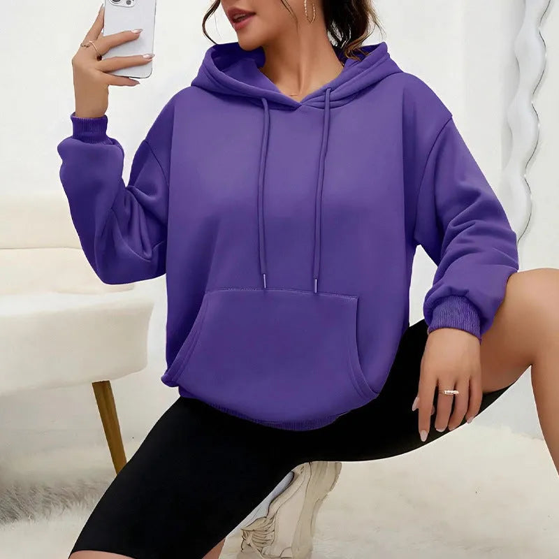 Women's loose grey sweatshirt with long sleeves and a front drawstring pocket.