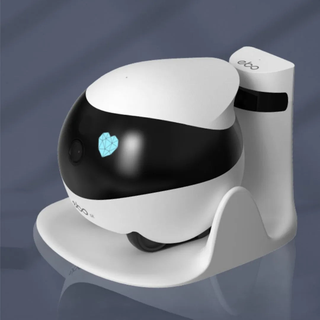 White smart home mobile surveillance robot camera on its automatic docking station.