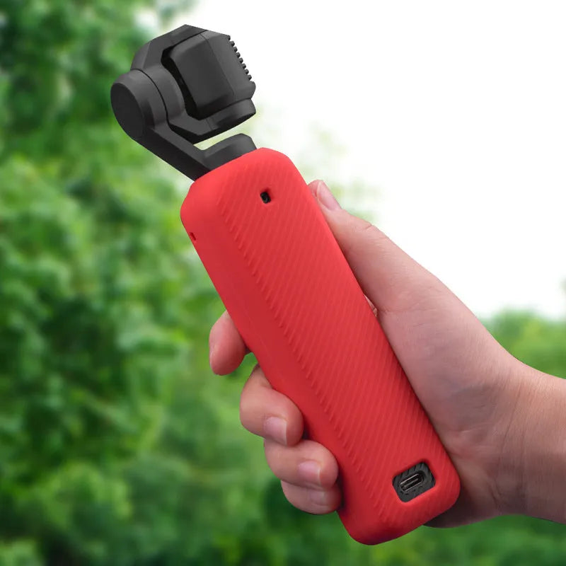 Black silicone protective sleeve cover for a PTZ camera motor body, shown next to red and orange versions.