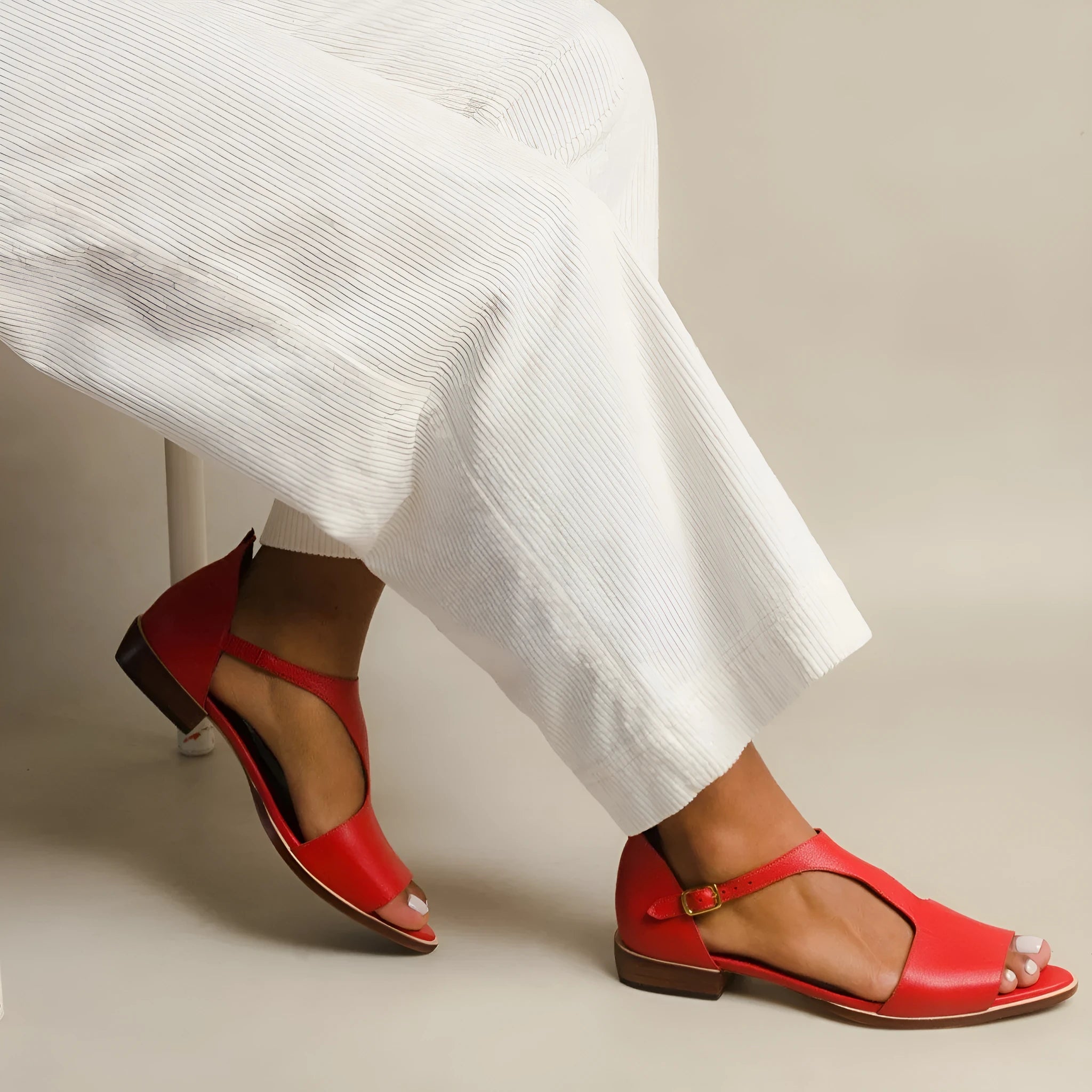 Red plus size women's sandals with square buckle and herringbone toe holder on a casual background.