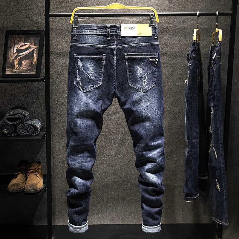Men's slim-fitting skinny jeans in dark blue cotton denim with micro elasticity, showing mid-waist trousers design