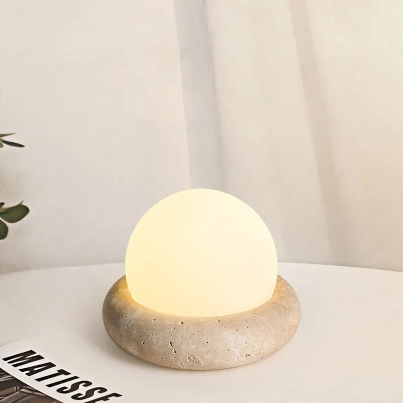 Cream coloured remote control bedside night light with circular 15.5cm diameter design