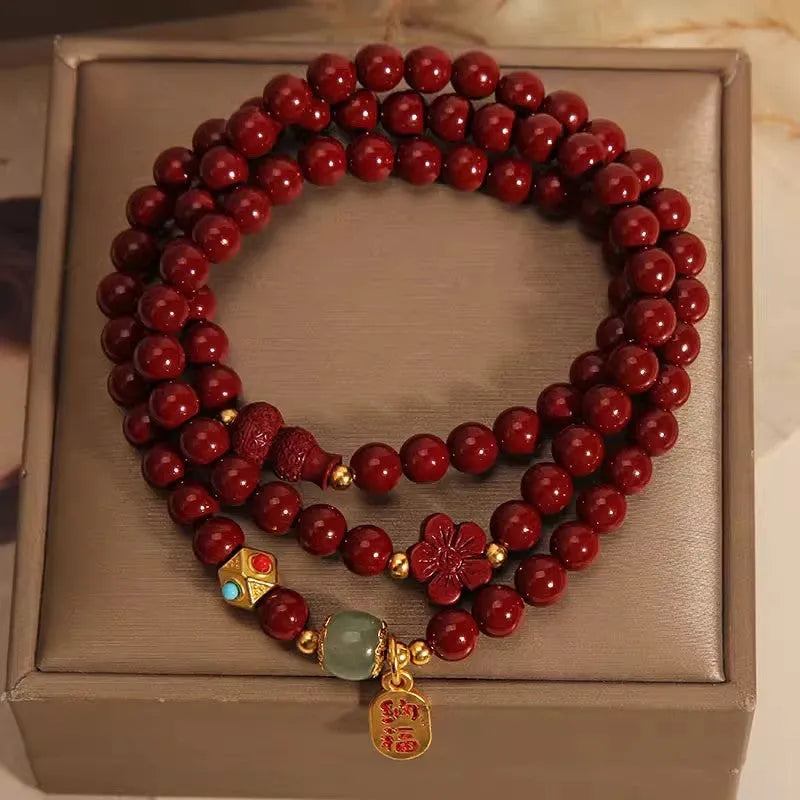 Red cinnabar bracelet with 6mm beads showing multi-circle gourd and five petal flower geometric design