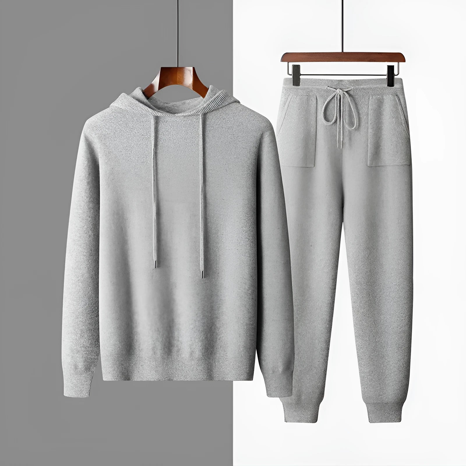 Men's light grey cashmere hooded sweatshirt and matching trousers laid flat.