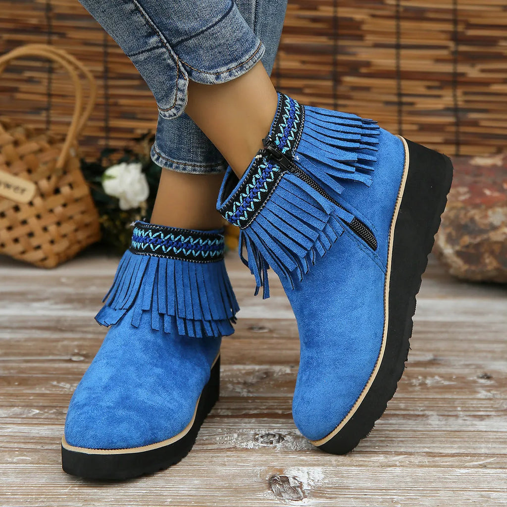 Women's dark brown suede ankle boots with a thick wedge sole, side zip, and decorative tassel.