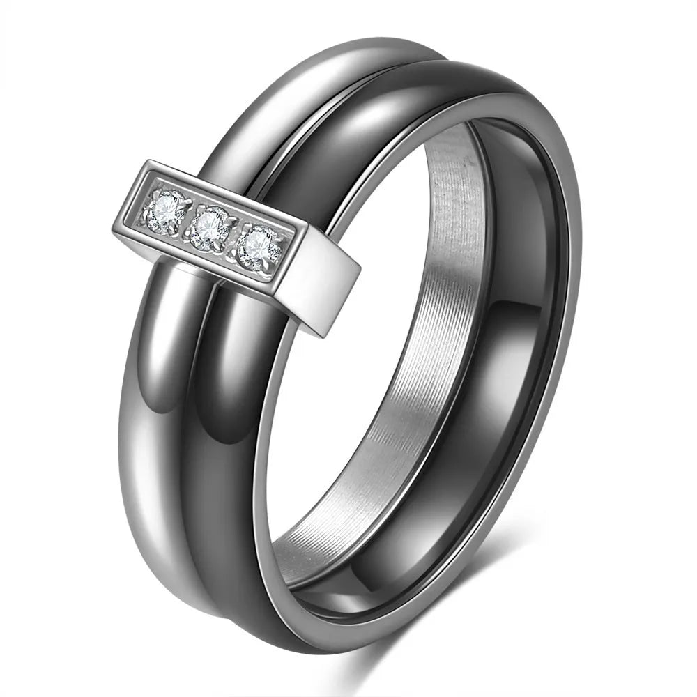 Glossy black ceramic women's ring with geometric shape and inlaid zirconium details on a finger.