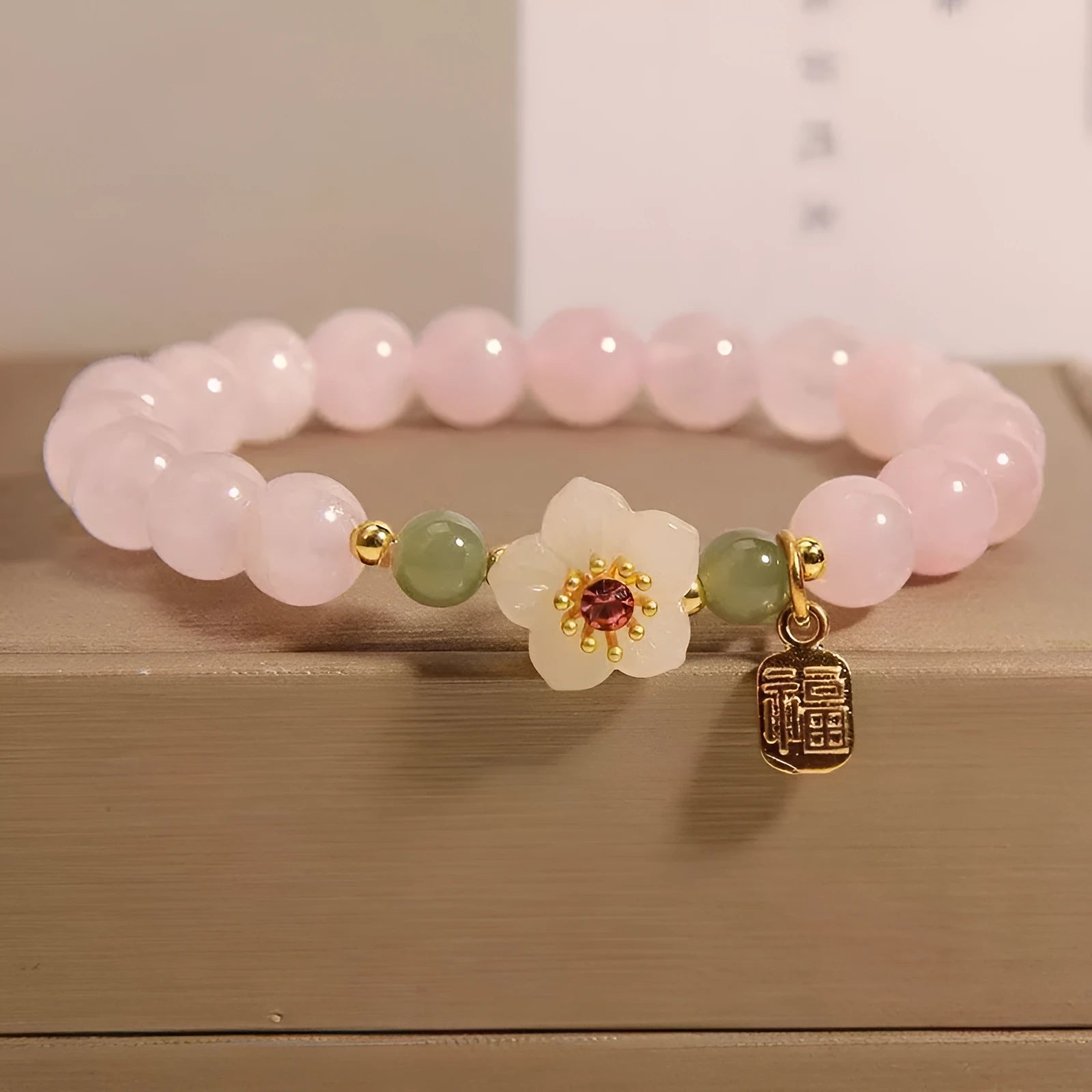 Crystal Hetian jade beaded peach blossom bracelet with camellia motifs and fruit charms in blessing card colour