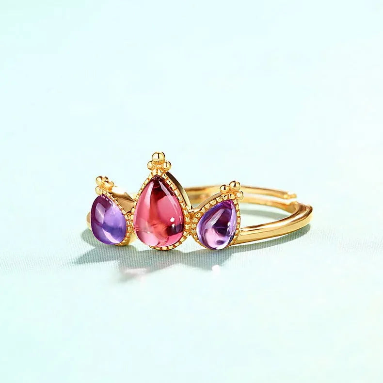 Sterling silver ring with drop-shaped garnet stone on finger, 925 silver, electroplated finish
