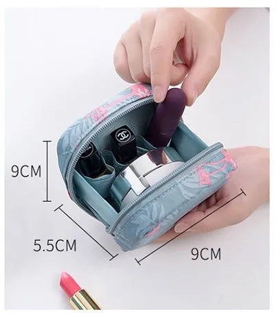 A blue cloth cube-shaped makeup storage bag on a table.