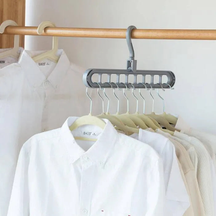 Pink plastic clothes hanger with a rotating hook on a white background.