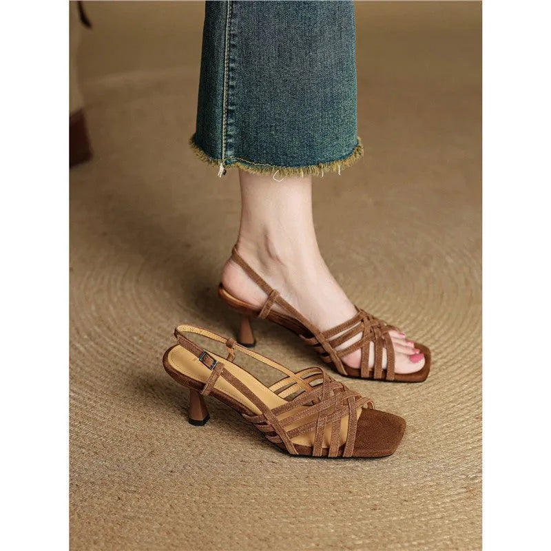 Retro beige high heel sandals with thin cross straps, an ankle buckle, and a square toe on a rubber sole.