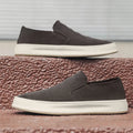 Men's grey casual shoes with round toe design and sewing line detailing showing rubber soles