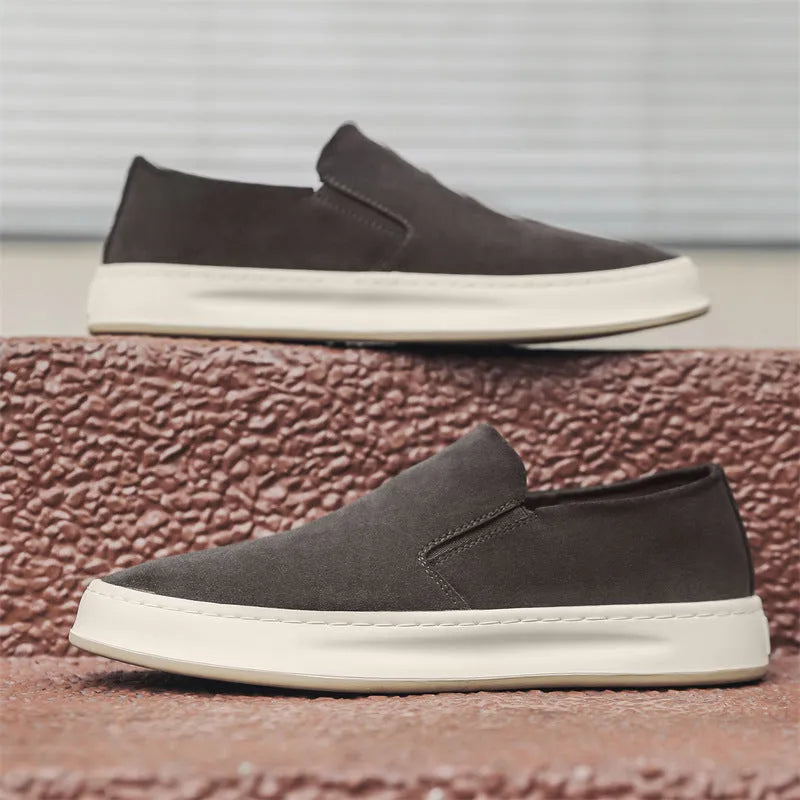 Men's grey casual shoes with round toe design and sewing line detailing showing rubber soles