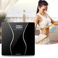 Black electronic household bathroom scale on a floor.