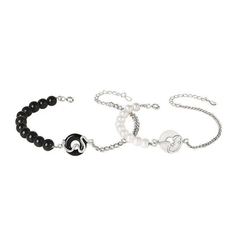Close-up of a 925 sterling silver bracelet with a snake design, obsidian pearl, and a safe buckle clasp.