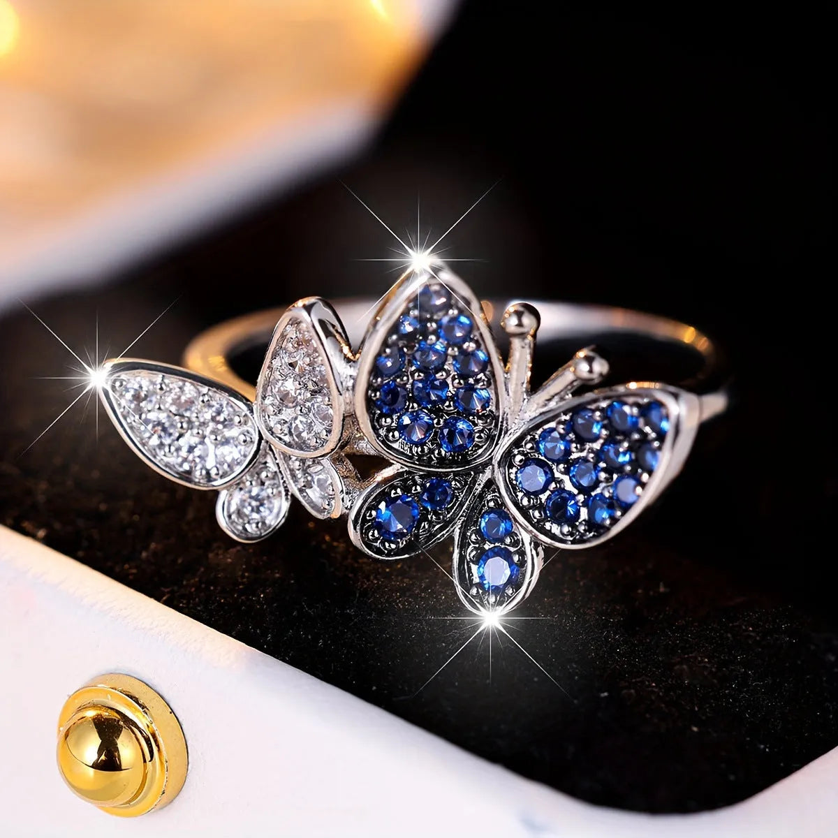 Blue and white butterfly design ring for women on a copper band, showing side detail.