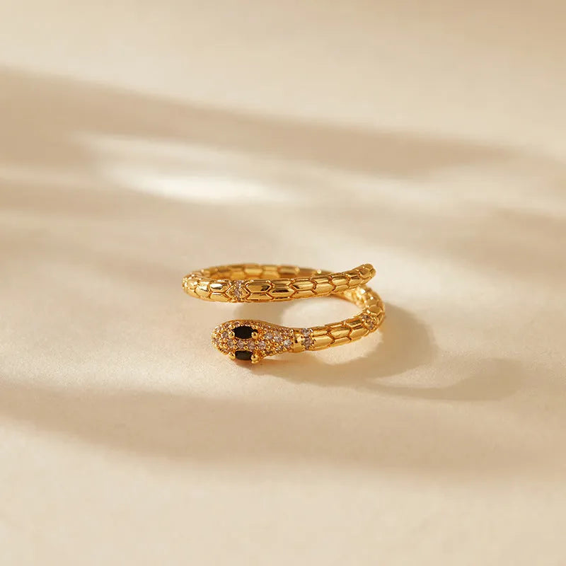 Copper snake ring with adjustable opening and gold colour plating, showing open mouth design