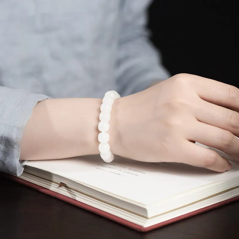 White Hetian jade barrel beads bracelet laid flat, showing bead sizes 5x6mm, 7x8mm, and 8x10mm.