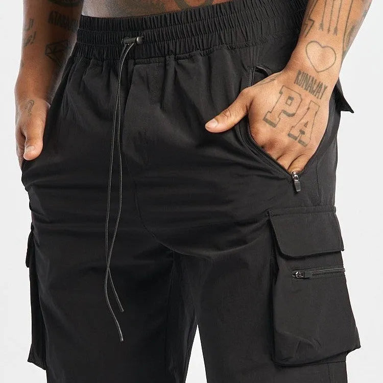 Men's black quick-dry sports shorts with elastic fabric for running and fitness activities