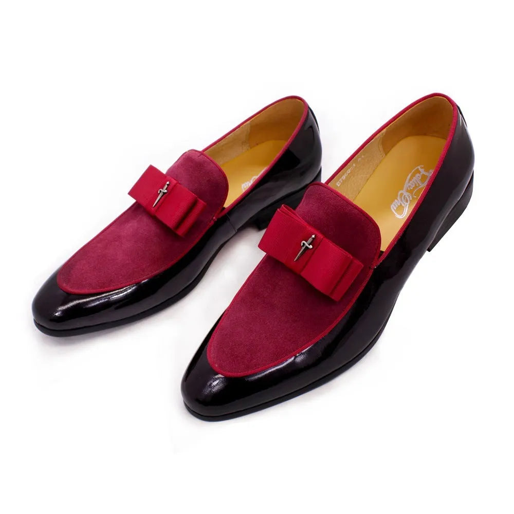 Men's glossy black patent leather low-top shoes featuring a gold tassel detail on a white background.