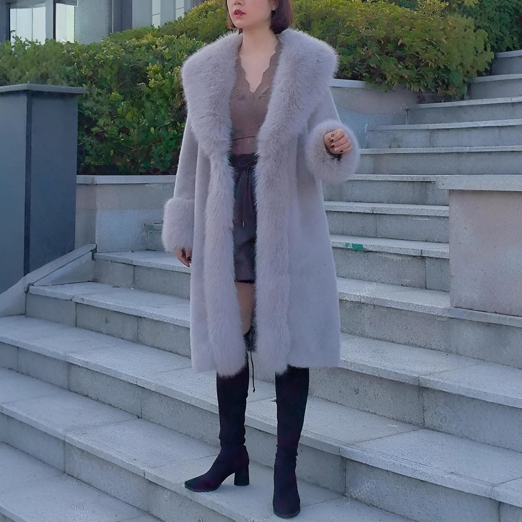 Grey women's mid-length faux fur coat with a leather panel and fur collar on a hanger.