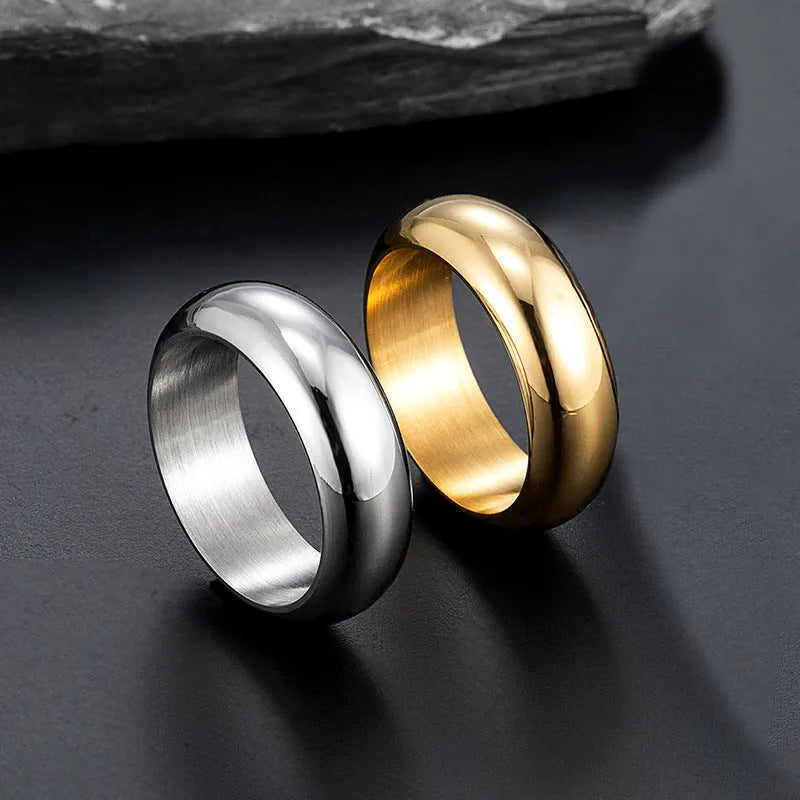 A glossy electroplated titanium steel ring shown in gold, black, and steel colour on a grey background.