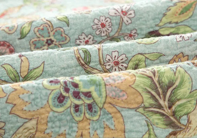 Blue American-style cotton bedspread with floral bird pattern, part of a 3-piece quilted set.