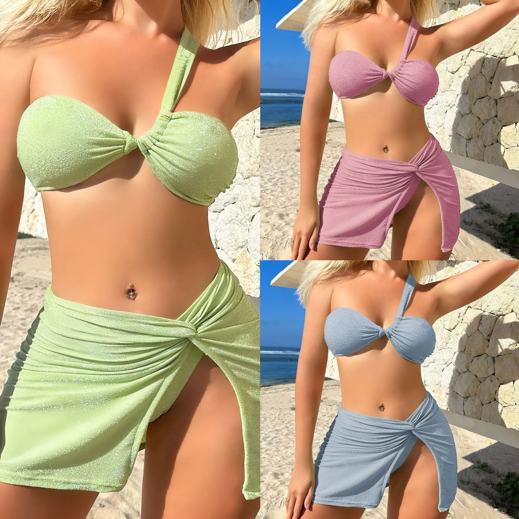 Women's light green one-shoulder swimsuit top with matching skirt and pants.