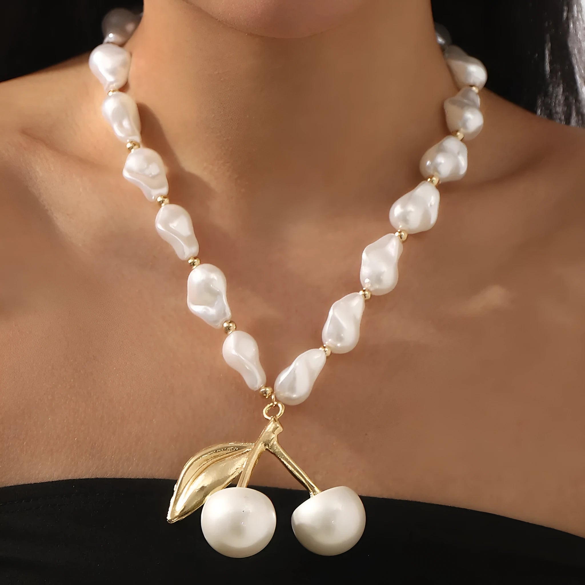 Women's creative necklace with gold alloy cherry fruit pendant on a white imitation pearl chain.