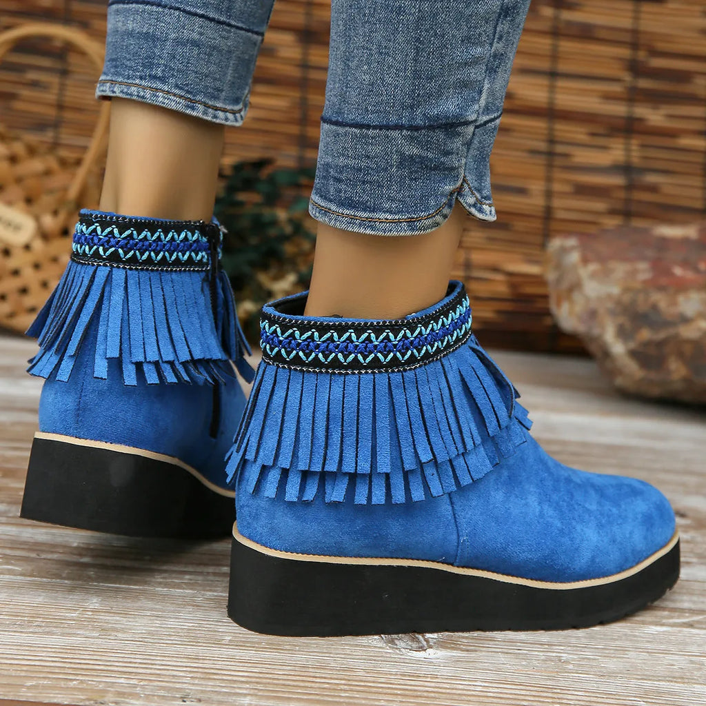 Women's dark brown suede ankle boots with a thick wedge sole, side zip, and decorative tassel.