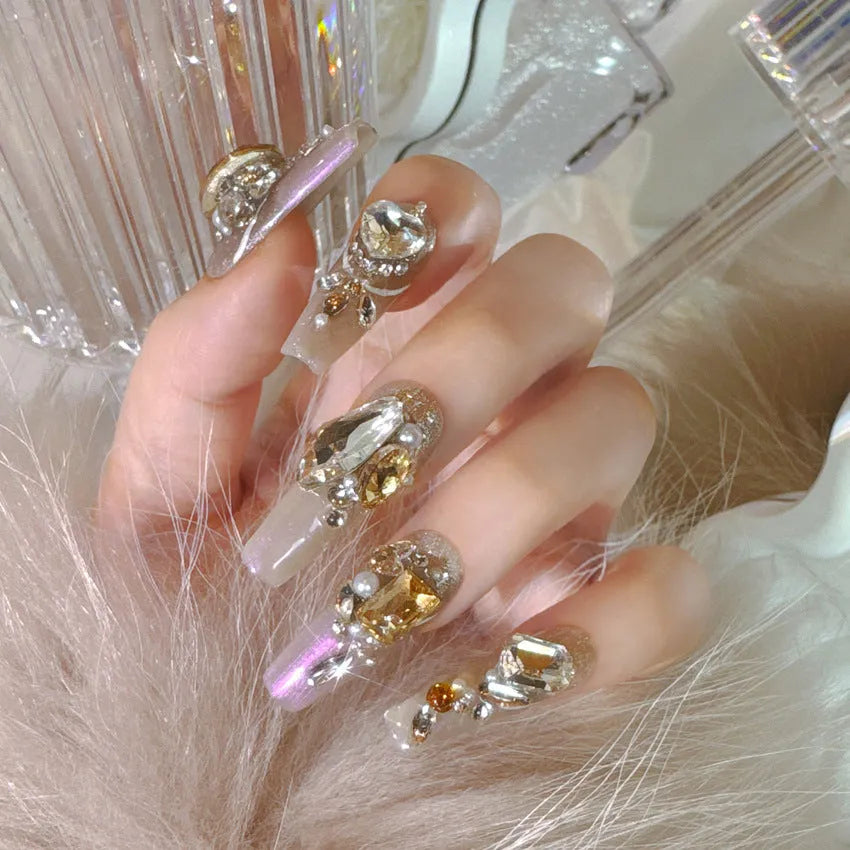 S number size luxury rhinestone false nail patches with jelly adhesive and tool options on card packaging.