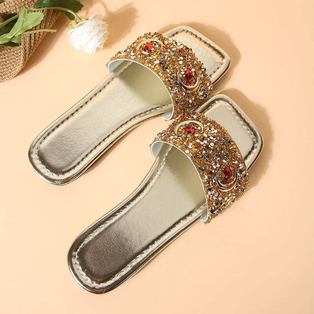 Gold women's slippers with rhinestone sequin detailing on flat rubber soles