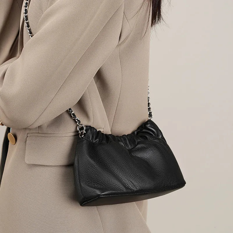 Women's soft genuine leather dumpling-shaped crossbody bag in grey with a chain shoulder strap.