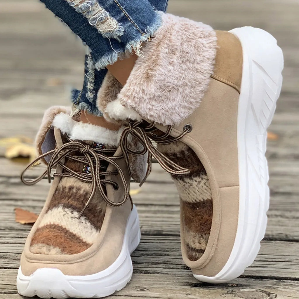 Women's beige suede lace-up snow boots with a thick platform sole and plush lining on a white background.