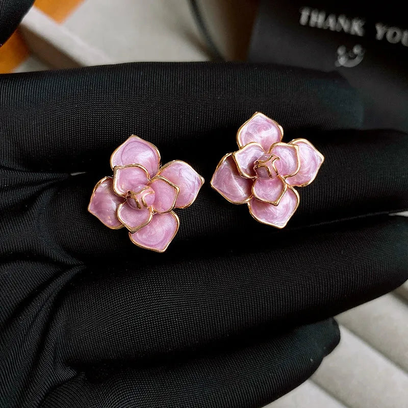 Gold plated copper flower stud earrings with purple oil-spot glaze finish and floral shape design