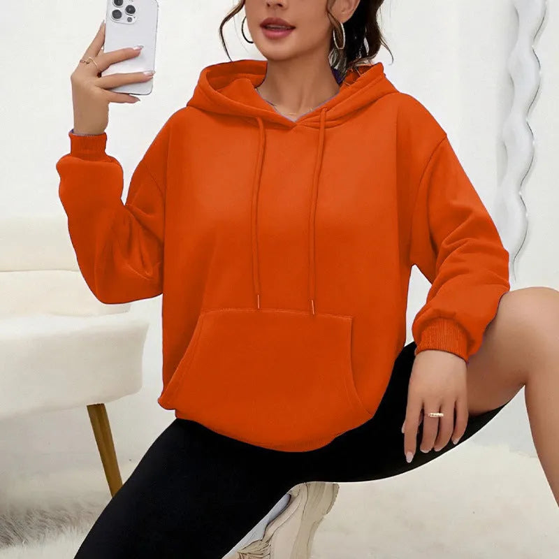 Women's loose grey sweatshirt with long sleeves and a front drawstring pocket.