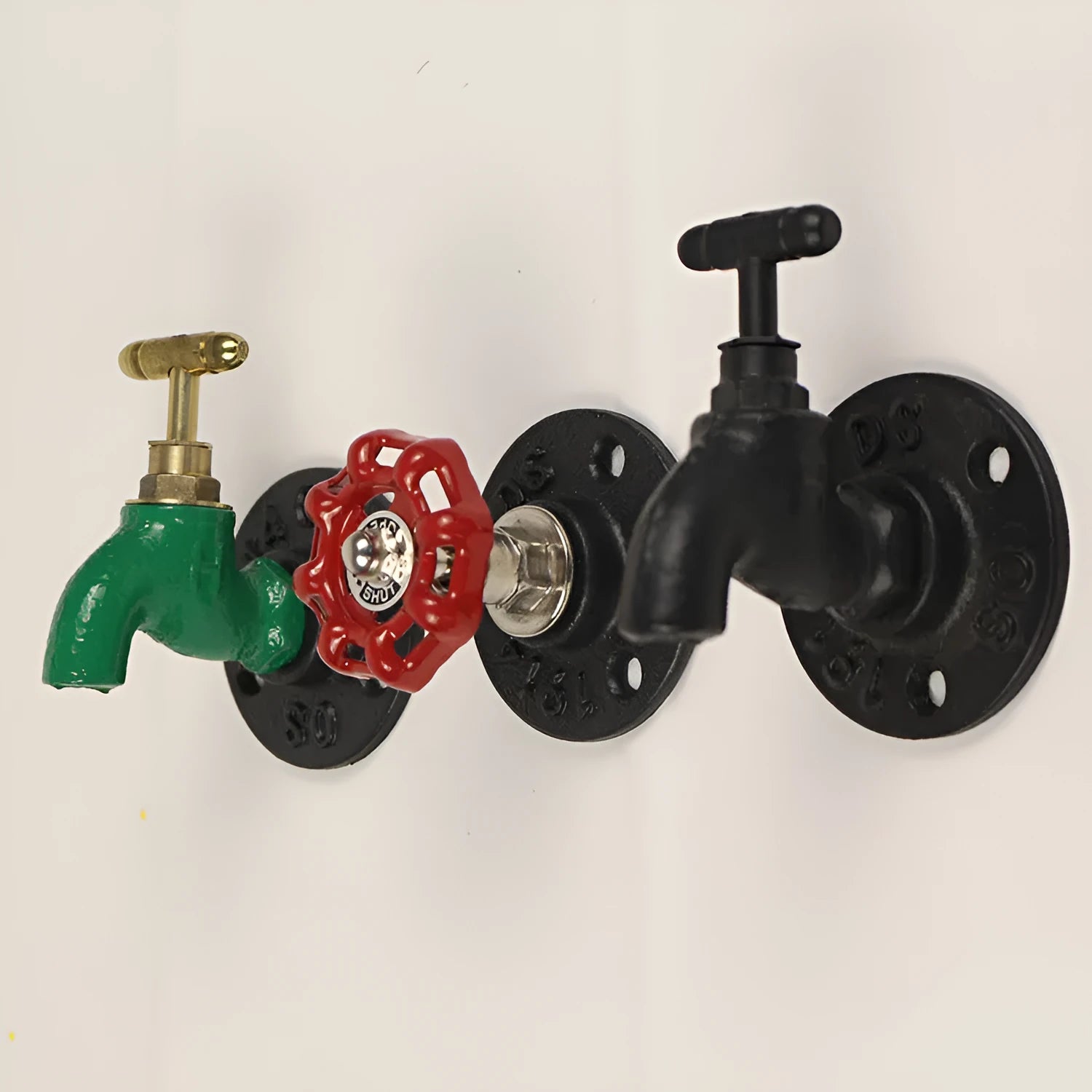 Water pipe style metal wall hook for towels on a white wall, shown in black, green, and red colour options.