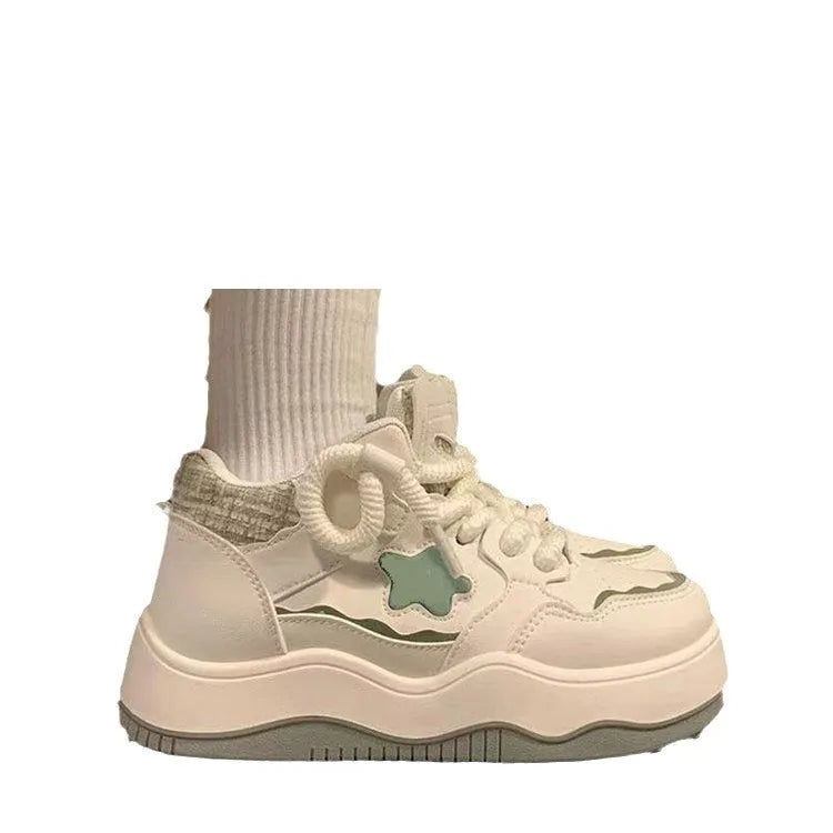 Women's green patent leather platform sneakers with front lace-up closure and rubber sole