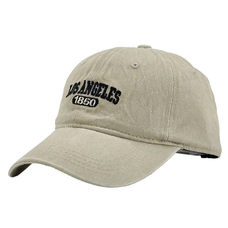 Retro personalised distressed peaked cap with embroidered letters, shown on adjustable strap, in navy blue colour.