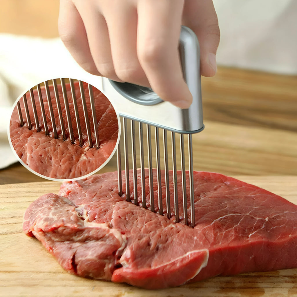 Stainless steel onion holder slicer kitchen tool with sharp prongs and finger guard on a cutting board.