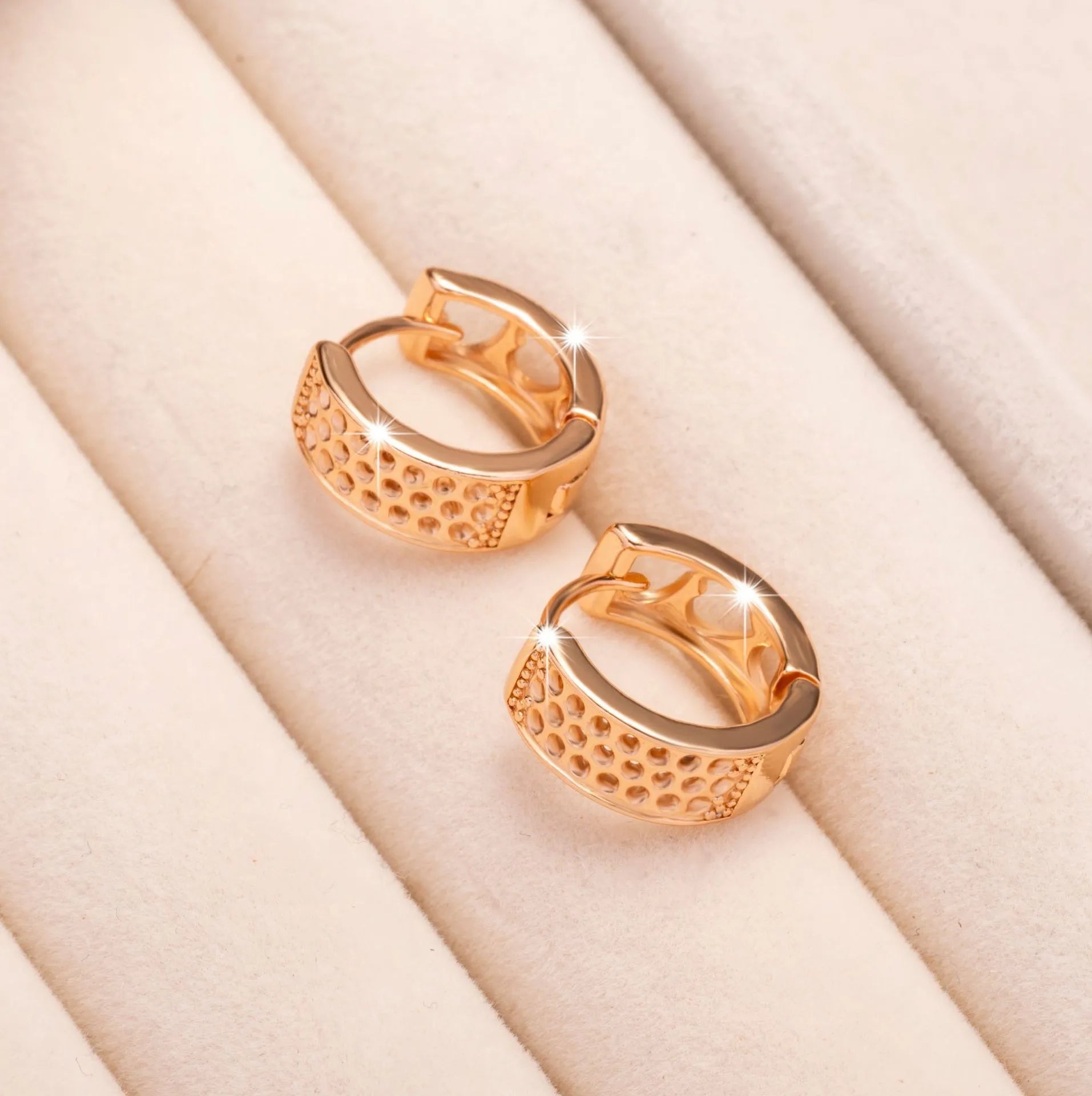 Rose gold women's earrings with three hollow heart shapes in circular arrangement