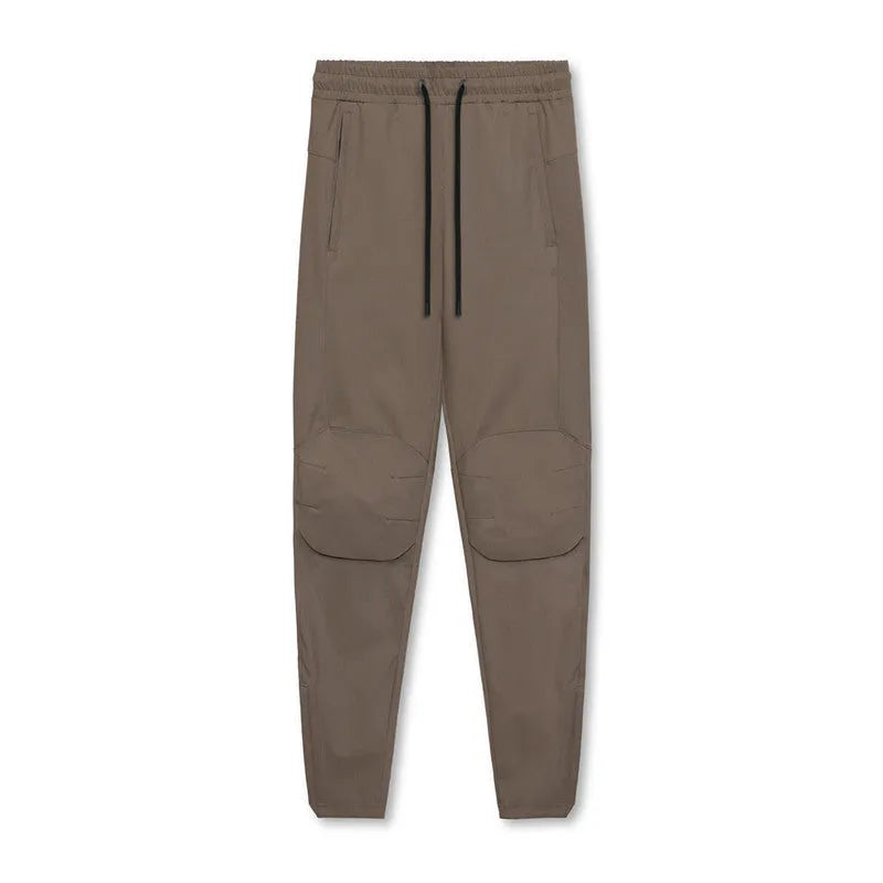Men's loose grey ankle-tied fitness pants with a casual cut for running and gym workouts.