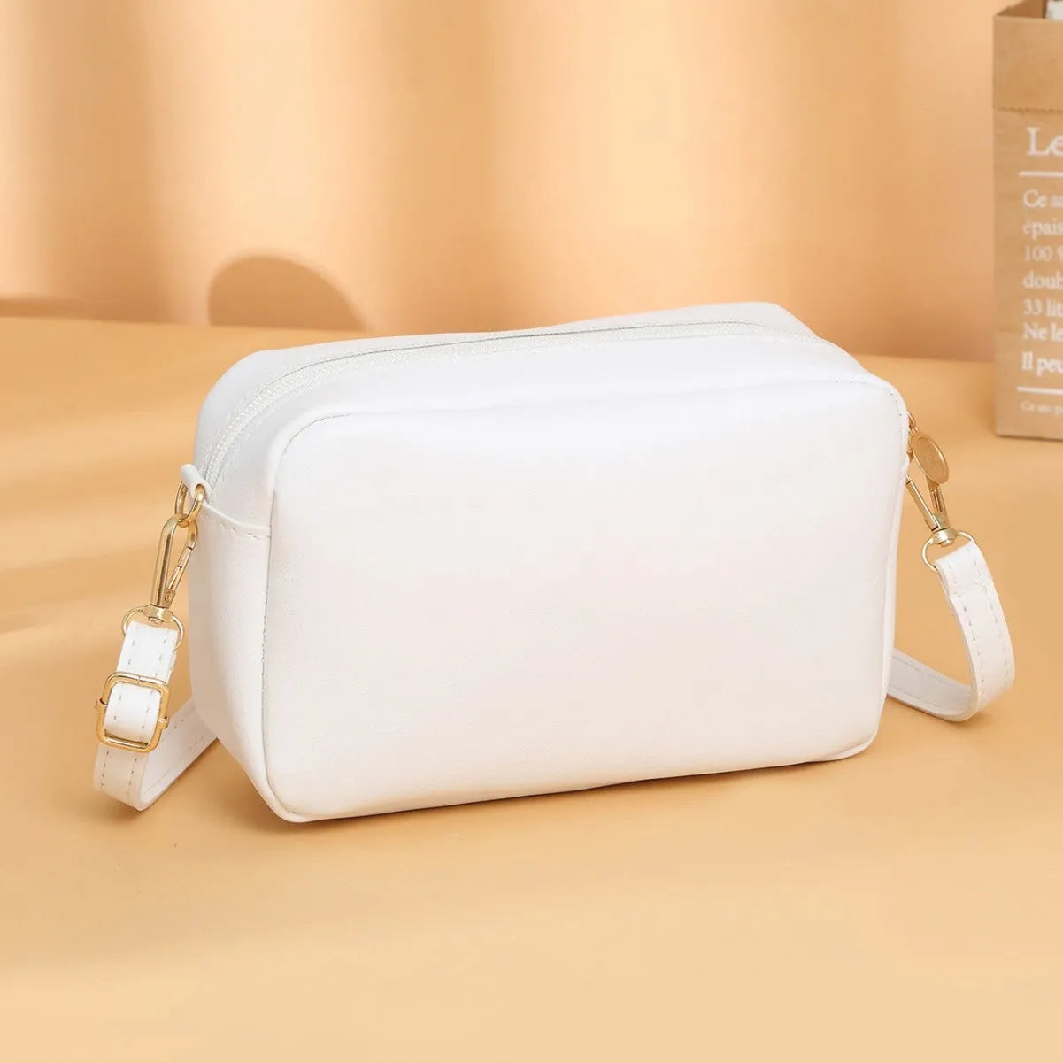 Women's solid colour PU shoulder bag with a horizontal square shape and a front pocket.