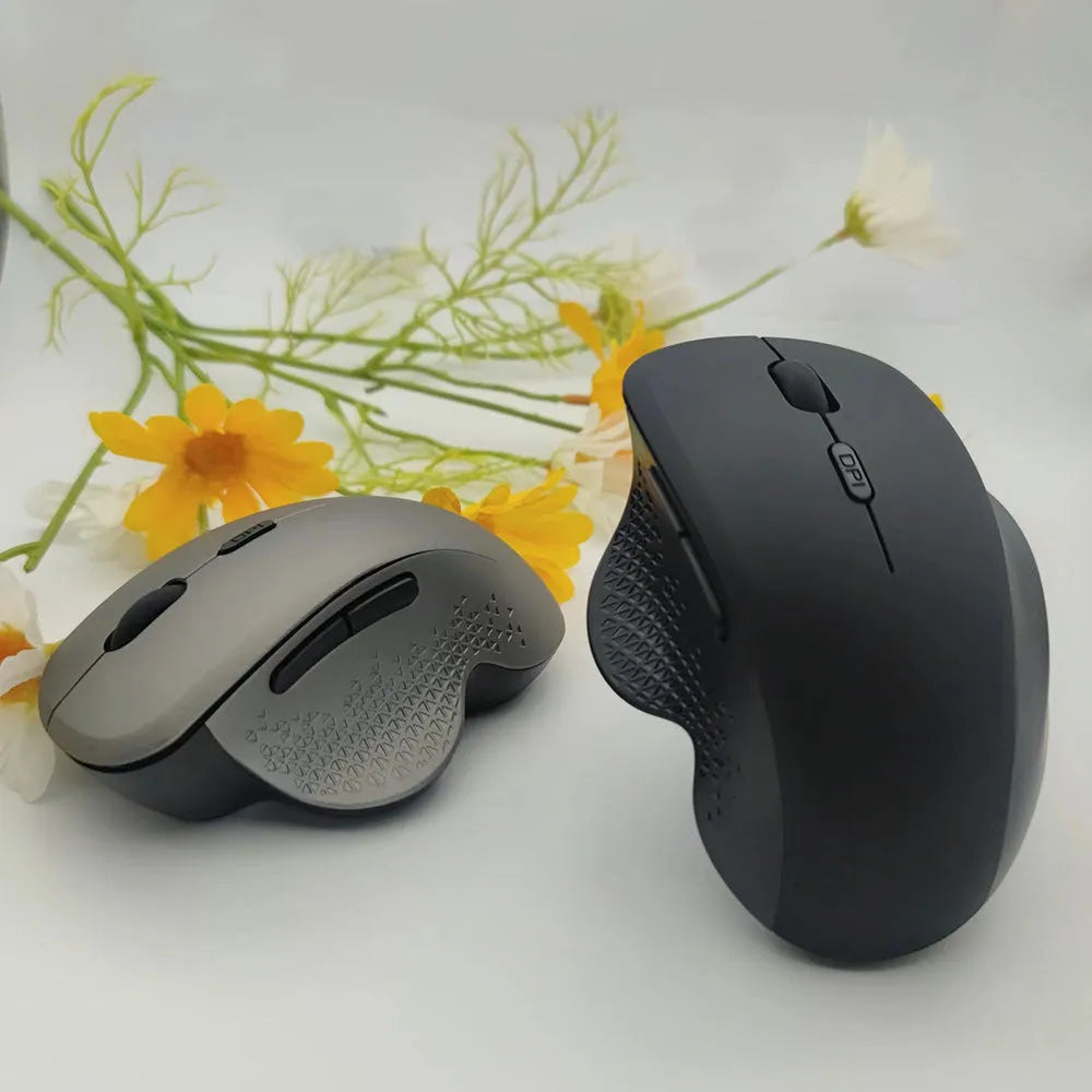 Black and grey wireless laptop mouse with USB charging cable on white background