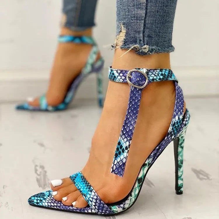 Blue women's high heels with buckle strap and hollow-out design on a pointed toe.