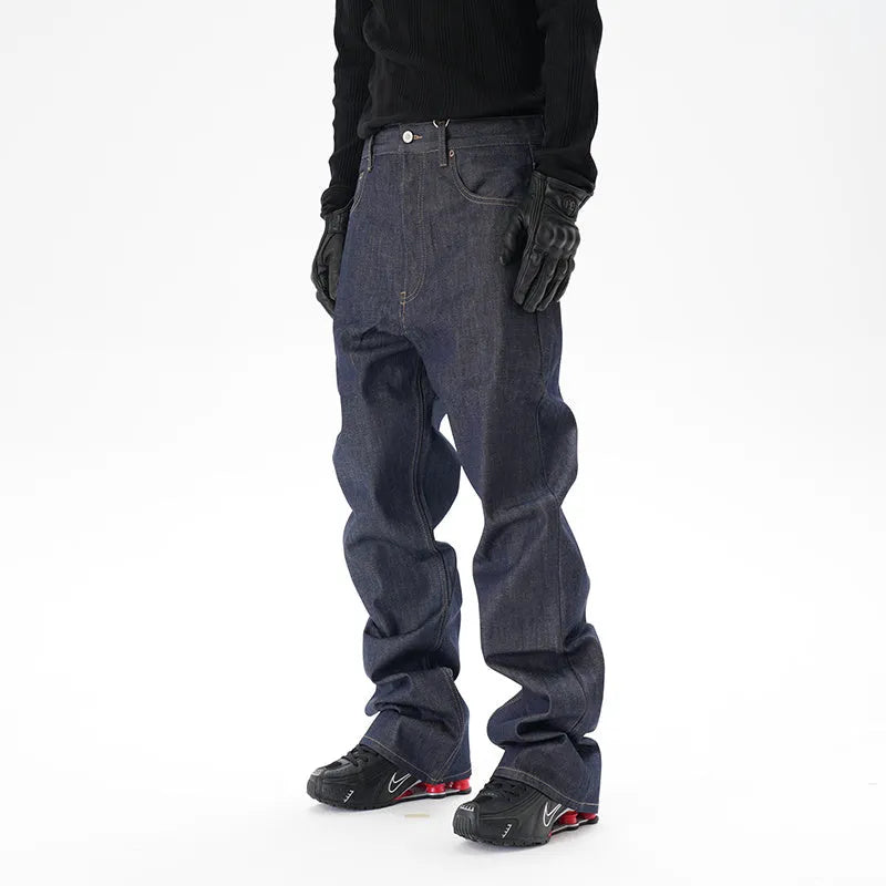 A pair of dark blue loose straight-cut jeans laid flat, showing the front design.