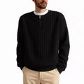A grey men's loose fit half zip pullover sweater with a textured knit and long sleeves.