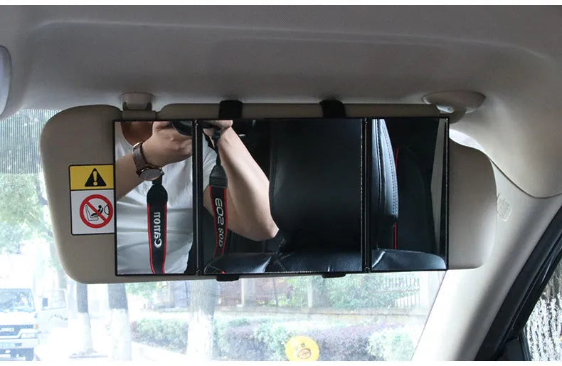 Silver portable car folding mirror shown both closed and opened on a flat surface.
