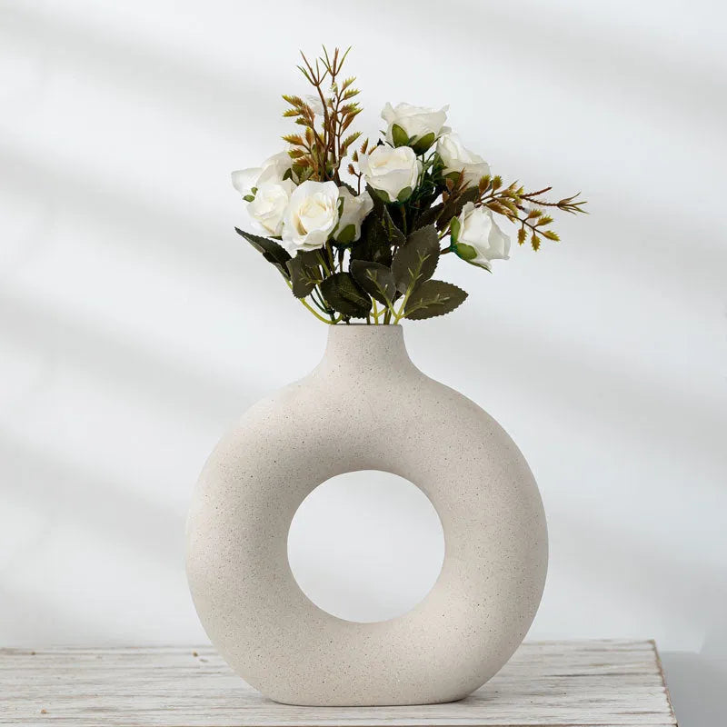 Frosted unglazed porcelain biscuit vase in a simple modern style on a table.